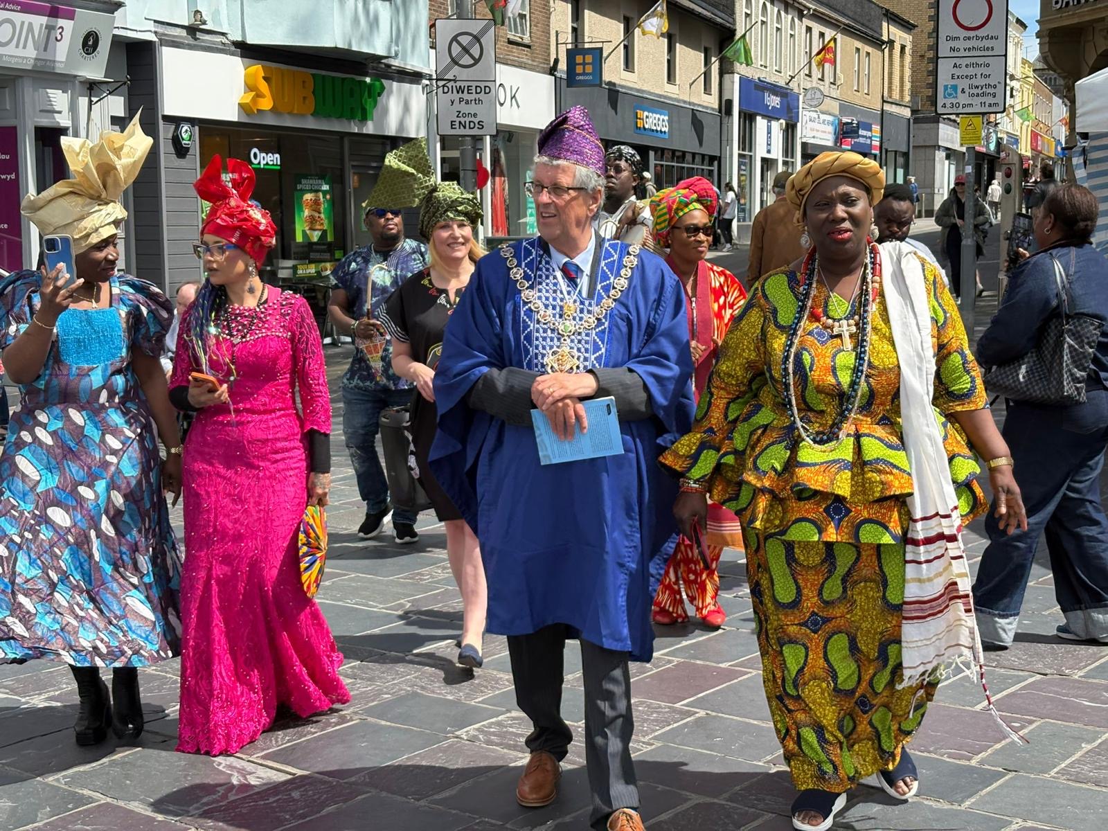 Community procession with participants and a civic guest
