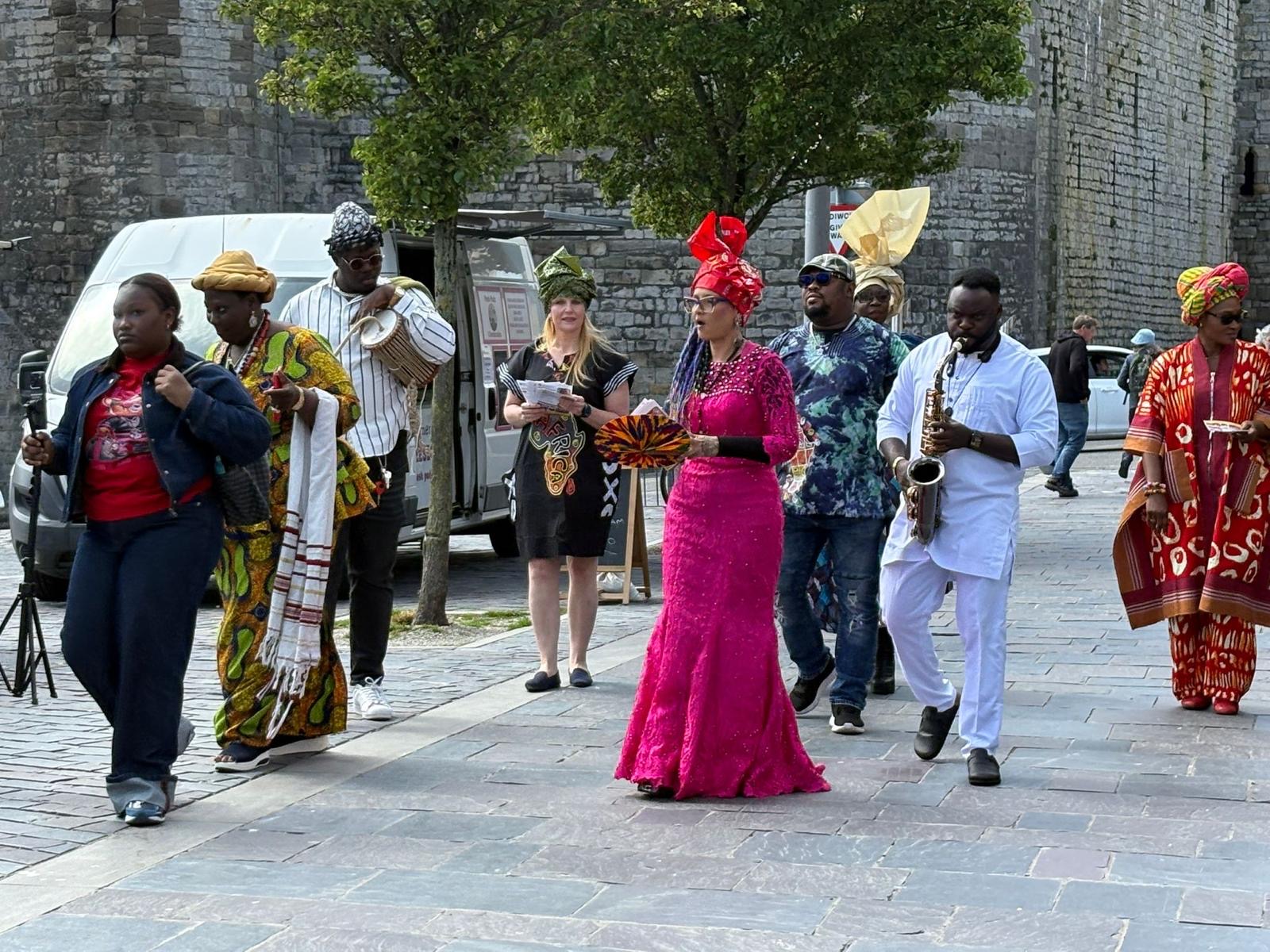 Street procession with musicians and participants in traditional attire